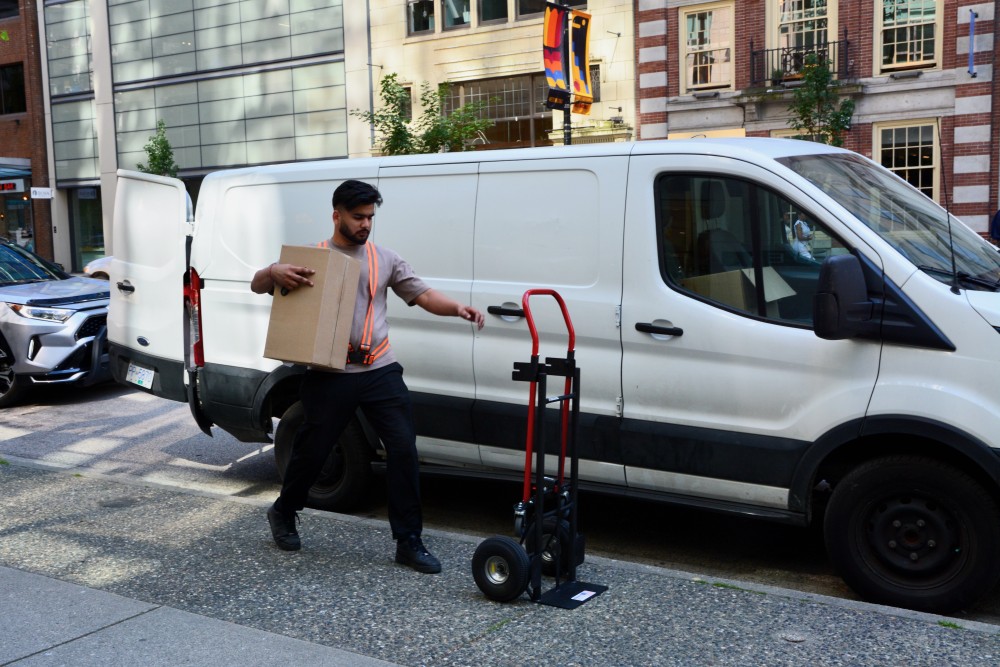 man using cargo van to deliver package