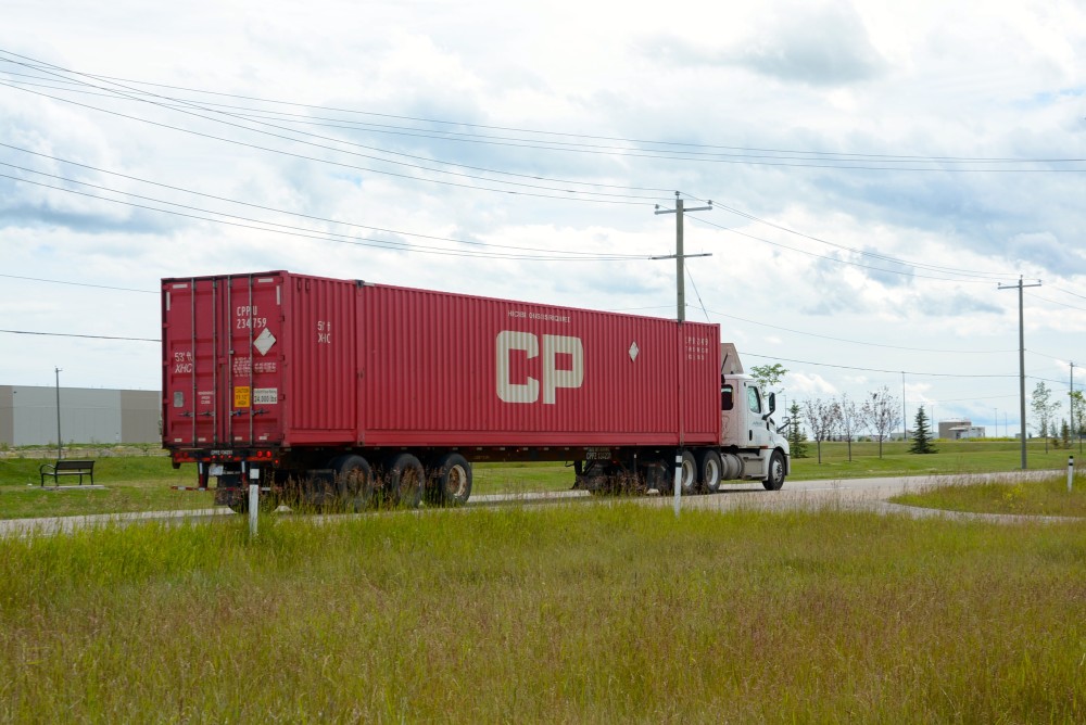 A shipping container truck transporting a CP container