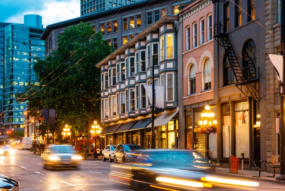 Cars driving by in a blur of motion in downtown Vancouver