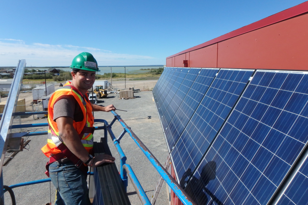 Solar installation in Behchoko with worker