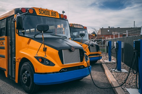 Lion electric school buses plugged in at a charging station