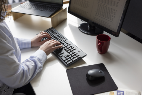 Person typing on a computer keyboard