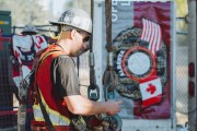 A worker in hard hat next to a union logo with Canadian and American flag