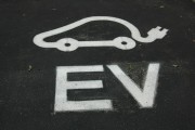 Icon of an electric vehicle displayed on ground of a parking spot