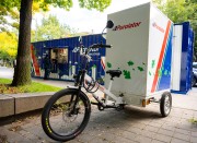 Purolator cargo bike in front of mini hub service window for last-mile parcel deliveries