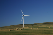 wind turbine in field with hay bales