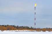 Methane flaring on a high pipe in winter