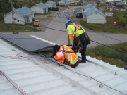 Workers installing solar panels in Kuujjuaq Quebec 