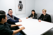 Women talking around a conference room table