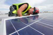 Worker installing solar panel